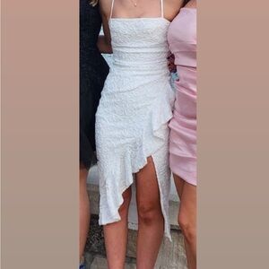 White floral lace mid dress. Has Spaghetti straps, and a wavy slit.